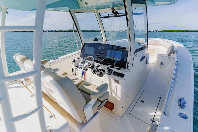  Yacht Photos Pics 2017 Cobia 344 Center Console boat interior with helm, steering wheel, and navigation equipment.