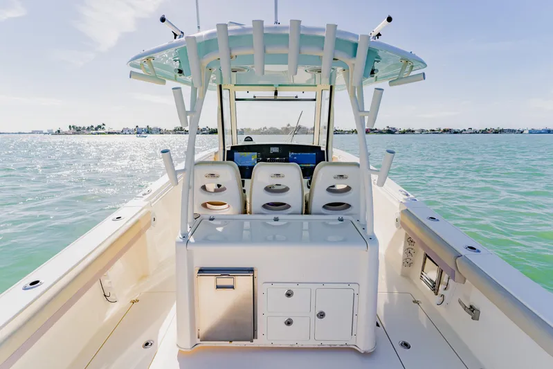  Yacht Photos Pics 2017 Cobia 344 Center Console boat on calm waters, featuring spacious deck and seating.