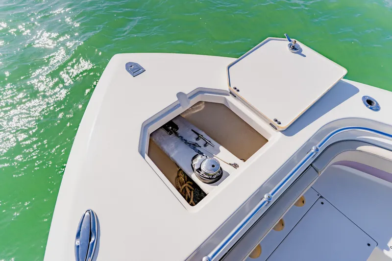  Yacht Photos Pics 2017 Cobia 344 Center Console boat anchor compartment on turquoise water.