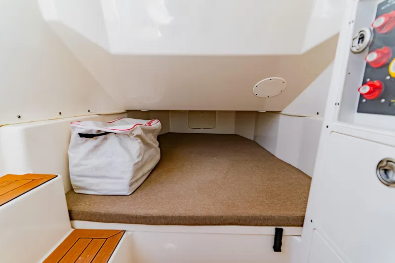  Yacht Photos Pics 2017 Cobia 344 Center Console cabin interior with storage bag and control panel.