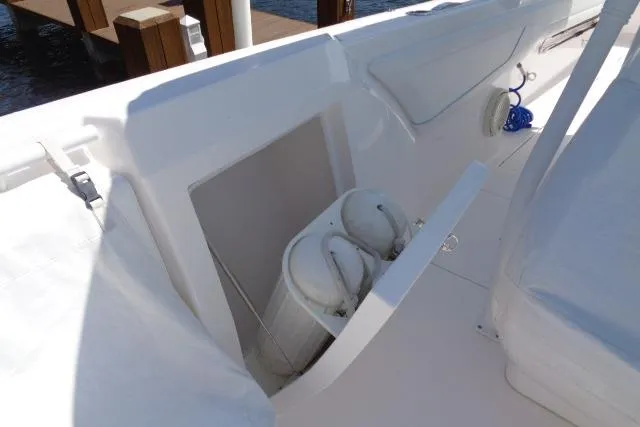  Yacht Photos Pics 2020 Intrepid 345 Nomad FE boat interior with storage compartment and white seating.