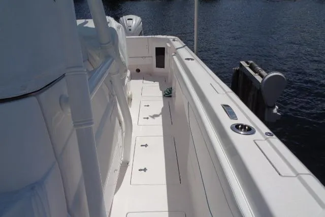  Yacht Photos Pics 2020 Intrepid 345 Nomad FE boat deck, white interior, docked by water.