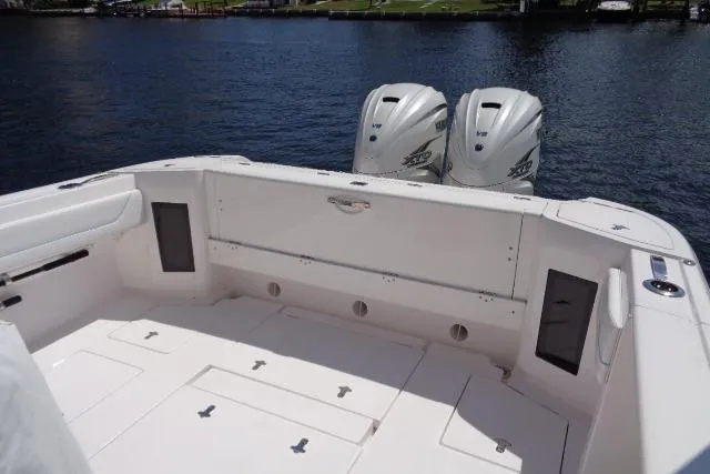  Yacht Photos Pics 2020 Intrepid 345 Nomad FE boat with twin outboard engines on a calm waterway.