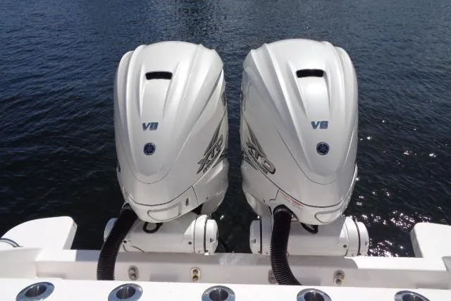  Yacht Photos Pics Twin V8 outboard engines on a 2020 Intrepid 345 Nomad FE boat, docked on water.