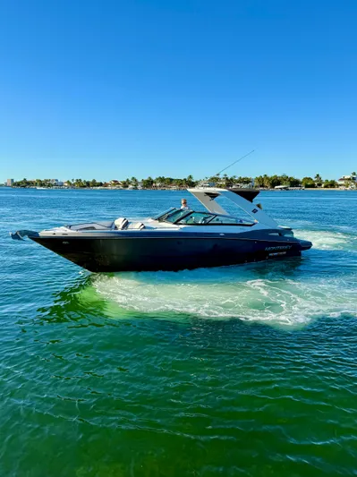  Yacht Photos Pics 2020 Monterey 328 SS boat cruising on clear blue water.