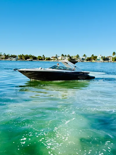  Yacht Photos Pics 2020 Monterey 328 SS boat cruising on clear blue water under a sunny sky.