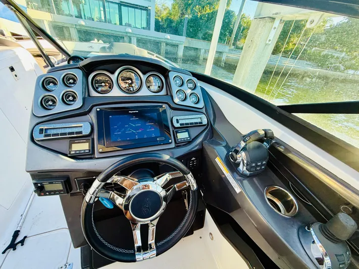  Yacht Photos Pics 2020 Monterey 328 SS boat dashboard with modern controls and steering wheel.