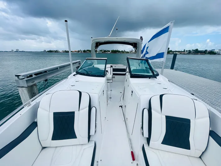 Yacht Photos Pics 2020 Monterey 328 SS boat docked, featuring sleek white seating and a flag.