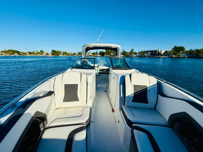  Yacht Photos Pics 2020 Monterey 328 SS boat on calm water, featuring luxurious seating and sleek design.