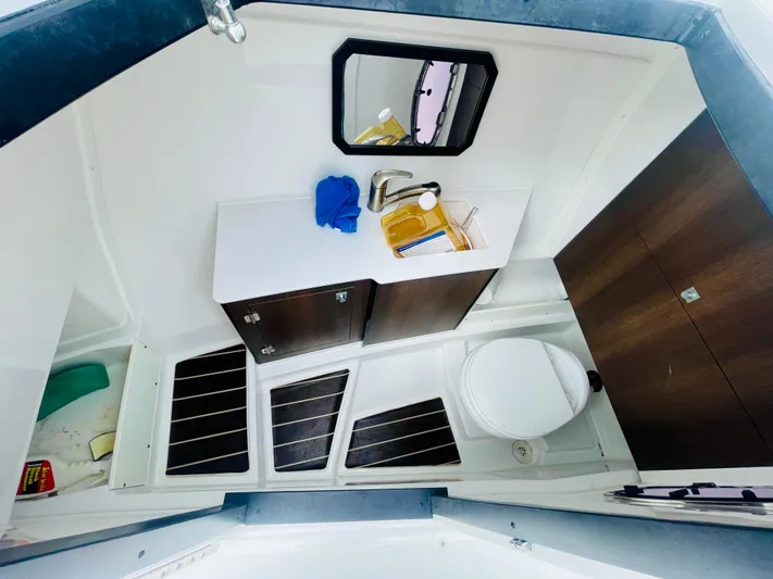 Yacht Photos Pics 2020 Monterey 328SS Super Sport boat bathroom with sink, mirror, and toilet.