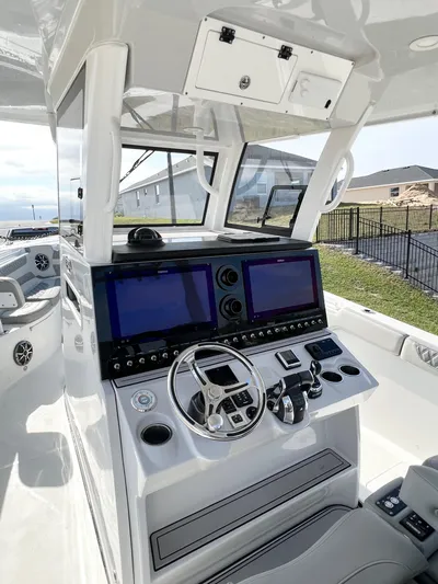  Yacht Photos Pics 2022 Sea Pro 320 DLX Offshore boat cockpit with dual screens and steering wheel.