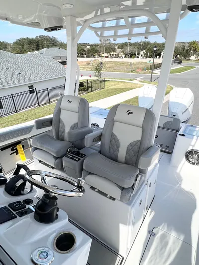  Yacht Photos Pics 2022 Sea Pro 320 DLX Offshore boat interior with dual captain's chairs and steering console.