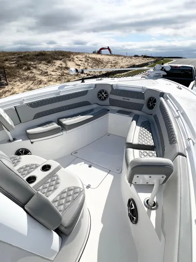  Yacht Photos Pics 2022 Sea Pro 320 DLX Offshore boat interior with cushioned seating and cup holders.