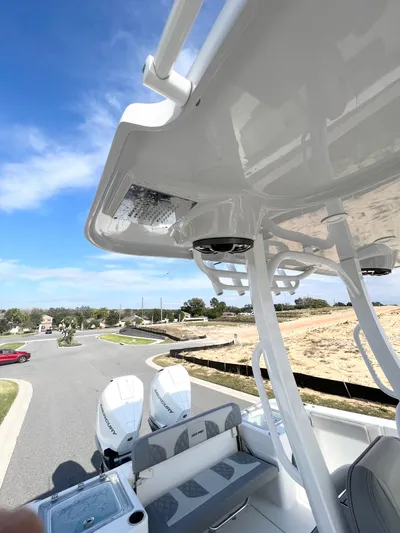  Yacht Photos Pics 2022 Sea Pro 320 DLX Offshore boat with dual engines and seating, under a clear blue sky.