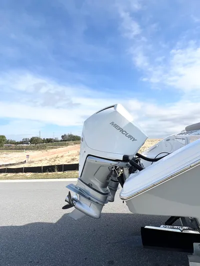  Yacht Photos Pics 2022 Sea Pro 320 DLX Offshore boat with Mercury outboard motor, parked on a sunny day.