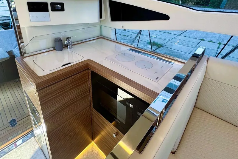 Custom Order Yours Today! Yacht Photos Pics Luxurious kitchen area in 2026 Cobrey 45 FLY yacht with modern appliances and sleek design.