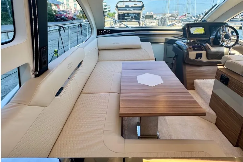 Custom Order Yours Today! Yacht Photos Pics Luxurious interior of 2026 Cobrey 45 FLY yacht with plush seating and modern dashboard.