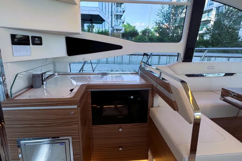 Custom Order Yours Today! Yacht Photos Pics Luxurious interior of 2026 Cobrey 45 FLY yacht with modern kitchen and seating area.