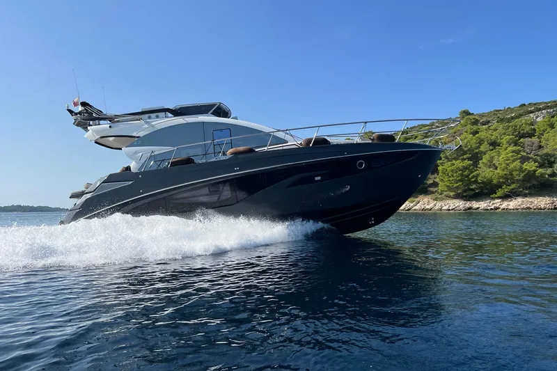 Custom Order Yours Today! Yacht Photos Pics Luxury Cobrey 45 FLY yacht cruising on clear blue waters, 2026 model.