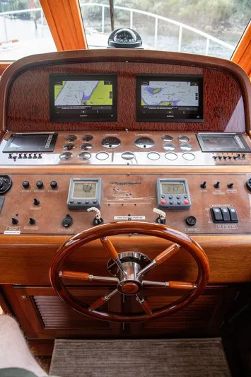 Grace Yacht Photos Pics Helm of 2007 Vicem 54 Classic Flybridge with dual navigation screens and wooden steering wheel.