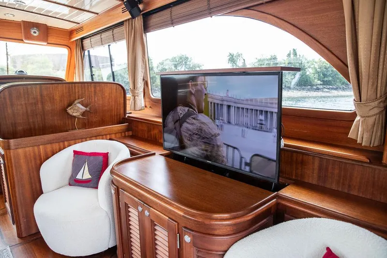 Grace Yacht Photos Pics Luxurious 2007 Vicem 54 Classic Flybridge yacht interior with TV and elegant wood finish.