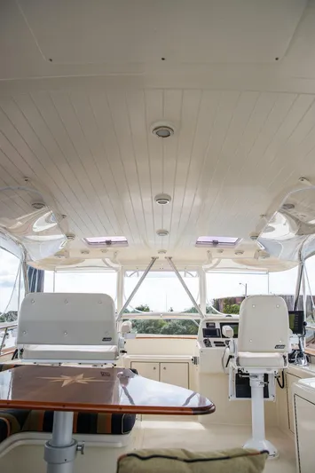 Grace Yacht Photos Pics 2007 Vicem 54 Classic Flybridge interior with helm chairs and navigation equipment.