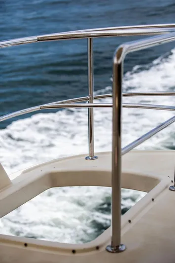 Grace Yacht Photos Pics Vicem 54 Classic Flybridge 2007 yacht railing with ocean waves in the background.