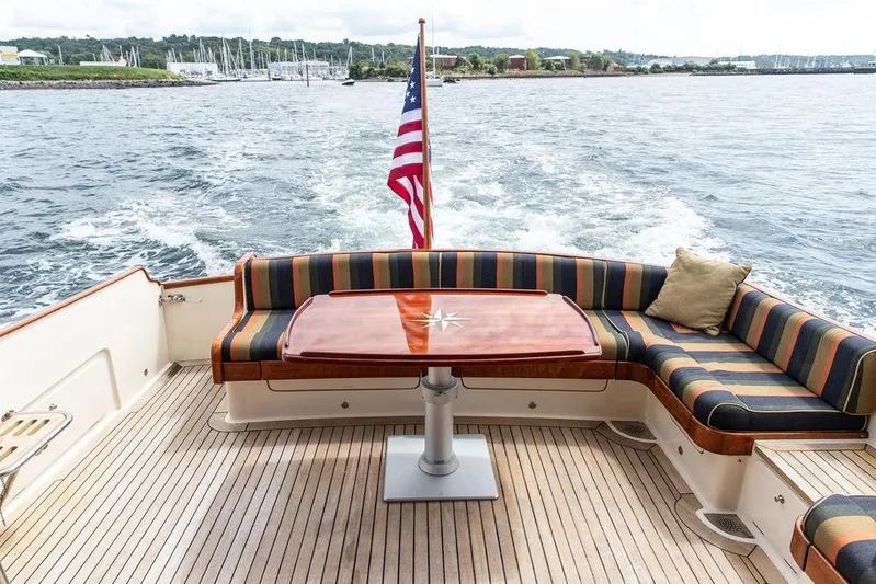Grace Yacht Photos Pics Vicem 54 Classic Flybridge 2007 yacht deck with striped seating and American flag.