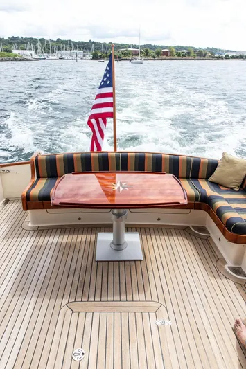 Grace Yacht Photos Pics Vicem 54 Classic Flybridge 2007 yacht deck with striped seating and American flag.