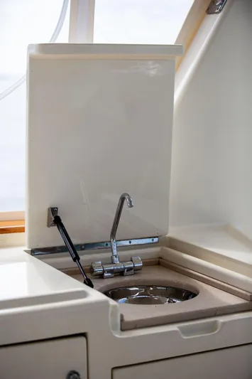 Grace Yacht Photos Pics Vicem 54 Classic Flybridge 2007 yacht sink with chrome faucet in compact kitchen area.