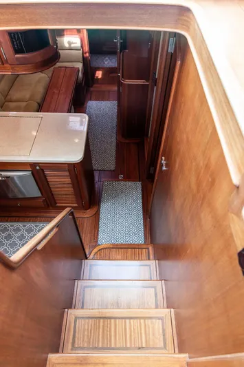 Grace Yacht Photos Pics Interior view of 2007 Vicem 54 Classic Flybridge yacht, featuring wooden stairs and elegant furnishings.