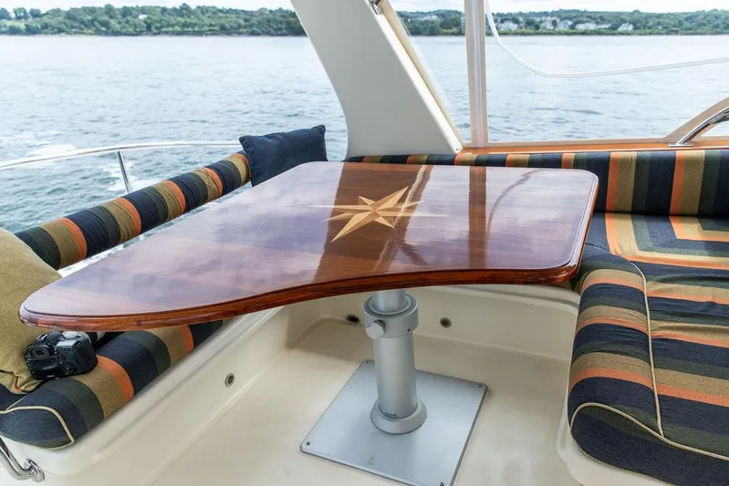 Grace Yacht Photos Pics Luxurious seating area on 2007 Vicem 54 Classic Flybridge yacht with polished wooden table.