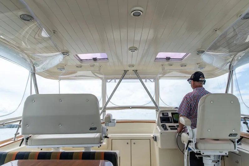 Grace Yacht Photos Pics Interior view of 2007 Vicem 54 Classic Flybridge yacht with captain at helm.