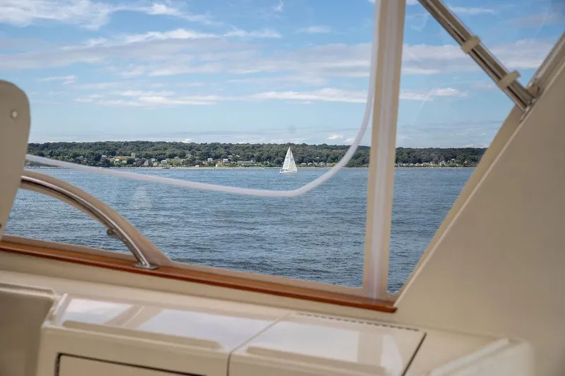 Grace Yacht Photos Pics View from 2007 Vicem 54 Classic Flybridge, overlooking serene waters and distant sailboat.