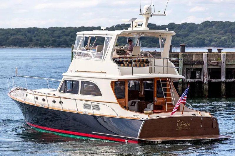 Grace Yacht Photos Pics 2007 Vicem 54 Classic Flybridge yacht docked near a pier, featuring elegant design and American flag.