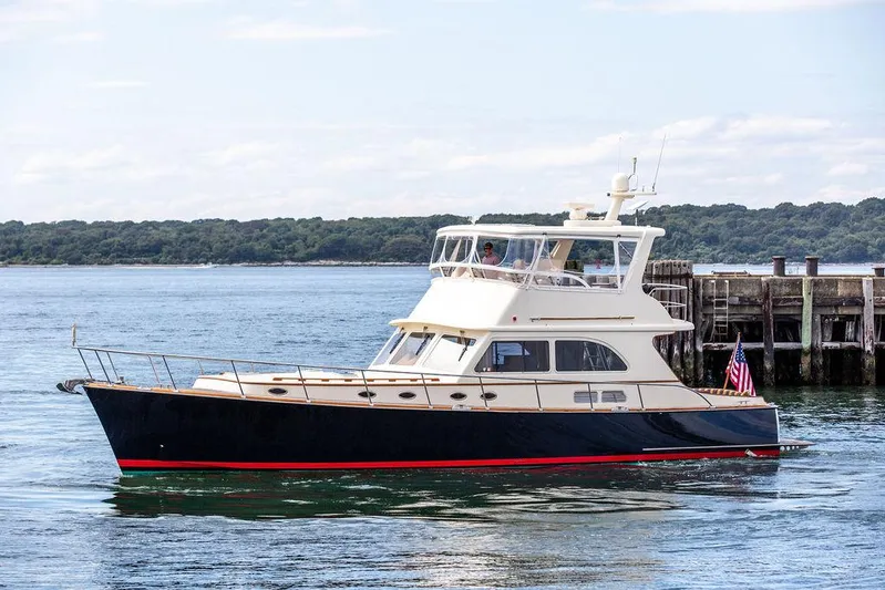 Grace Yacht Photos Pics 2007 Vicem 54 Classic Flybridge yacht cruising near a dock on a sunny day.