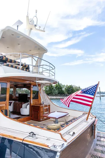 Grace Yacht Photos Pics 2007 Vicem 54 Classic Flybridge yacht with American flag, docked by the water.