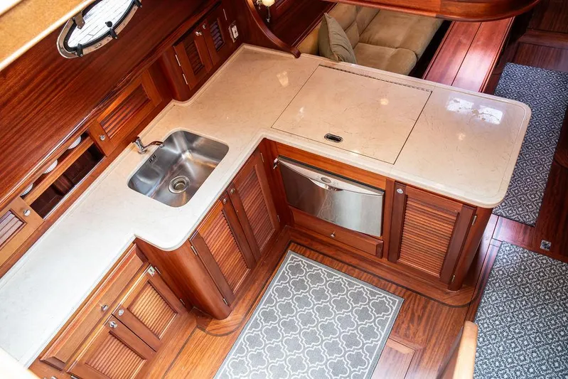 Grace Yacht Photos Pics Luxurious 2007 Vicem 54 Classic Flybridge yacht kitchen with wood cabinetry and modern amenities.