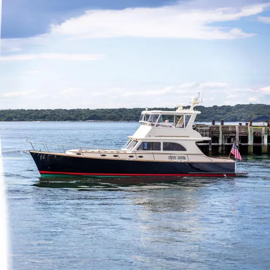 Grace Yacht Photos Pics 2007 Vicem 54 Classic Flybridge yacht docked by the pier, with scenic water backdrop.