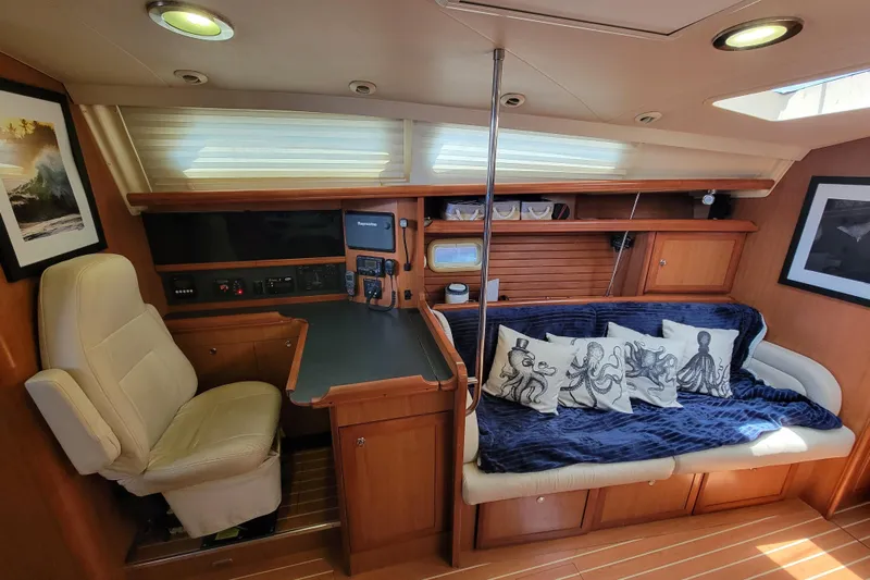 Slip Aweigh Yacht Photos Pics Interior of a 2009 Hunter 49 yacht with cozy seating and nautical decor.
