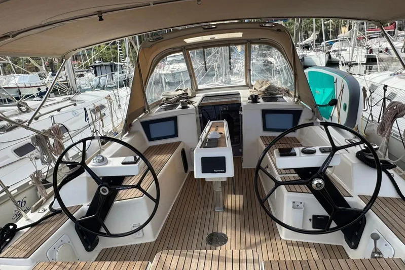 Insania Yacht Photos Pics 2019 Dufour 360 Grand Large yacht cockpit with dual steering wheels and navigation screens.