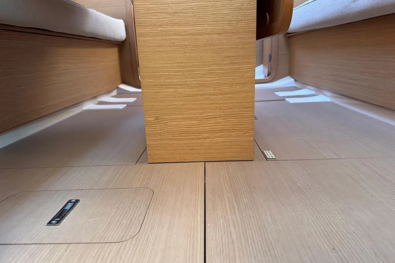 Insania Yacht Photos Pics Interior view of 2019 Dufour 360 Grand Large sailboat, showcasing wooden flooring and seating.