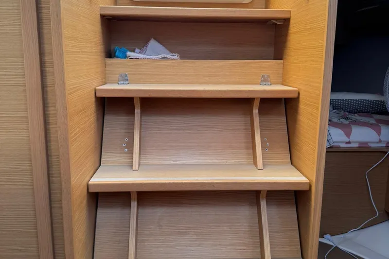 Insania Yacht Photos Pics Wooden interior steps of a 2019 Dufour 360 Grand Large sailboat.