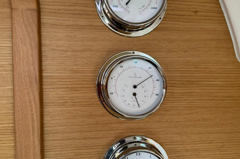 Insania Yacht Photos Pics Chrome nautical gauges on Dufour 360 Grand Large 2019 yacht's wooden panel.