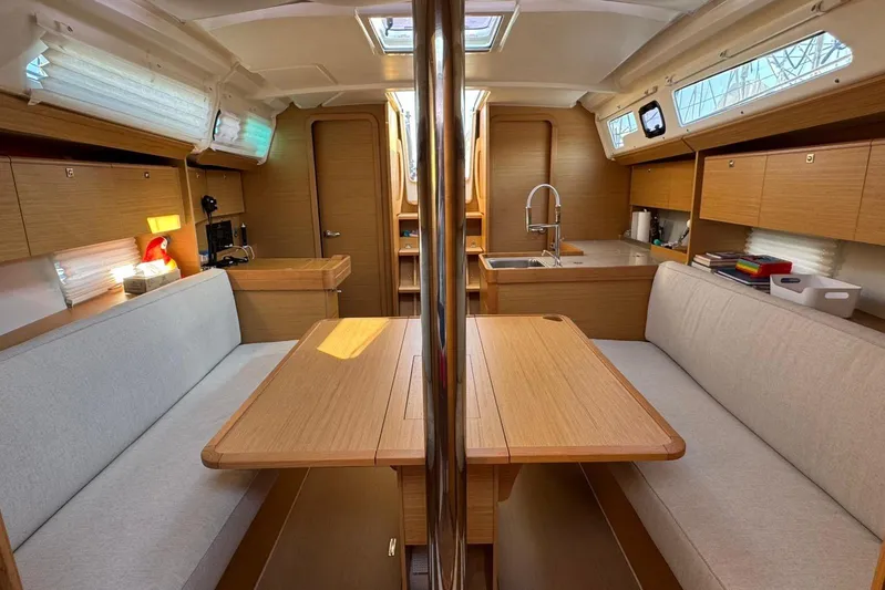 Insania Yacht Photos Pics Interior of 2019 Dufour 360 Grand Large yacht, featuring cozy seating and modern kitchen.
