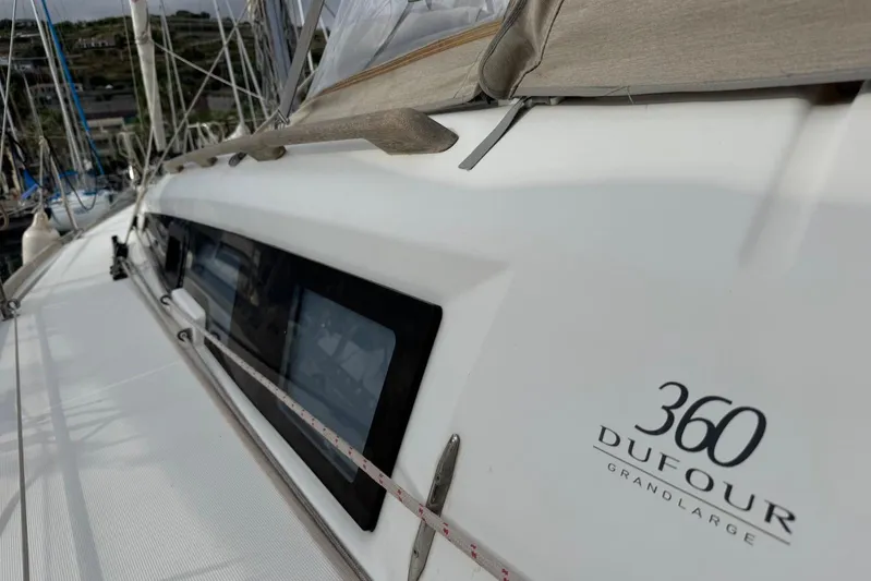Insania Yacht Photos Pics 2019 Dufour 360 Grand Large sailboat, side view with logo and deck details.