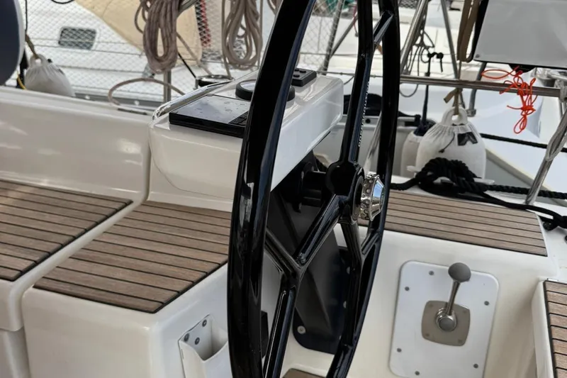 Insania Yacht Photos Pics Steering wheel of 2019 Dufour 360 Grand Large sailboat, featuring teak decking.