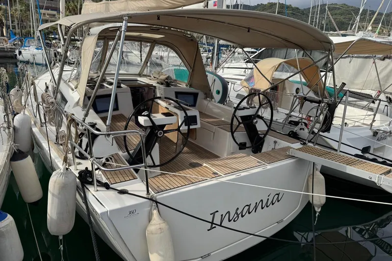 Insania Yacht Photos Pics 2019 Dufour 360 Grand Large sailboat docked, featuring dual steering wheels and teak decking.