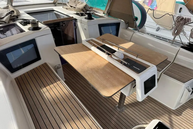 Insania Yacht Photos Pics 2019 Dufour 360 Grand Large yacht cockpit with wooden seating and table.