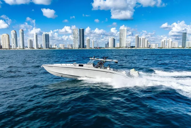 Trigger Yacht Photos Pics 2022 Midnight Express 43' Solstice cruising near city skyline on a sunny day.